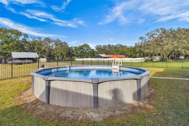 view of pool with a lawn