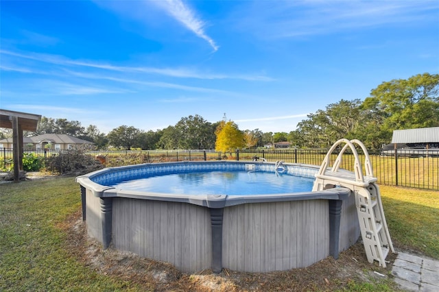 view of pool featuring a yard