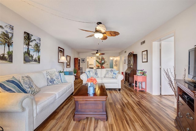 living room with wood-type flooring and ceiling fan