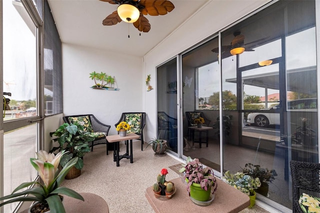 sunroom / solarium featuring ceiling fan