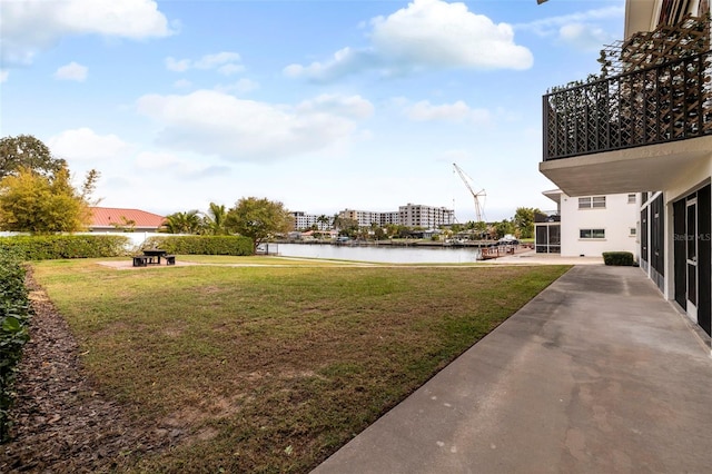 view of yard with a water view and a balcony