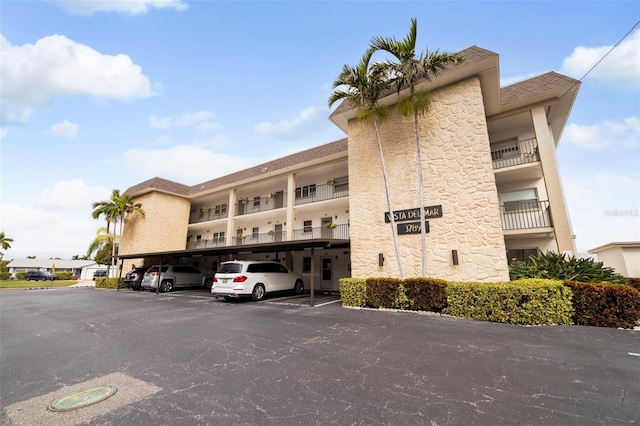 view of building exterior featuring covered parking