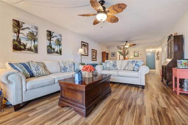 living room with a ceiling fan and wood finished floors