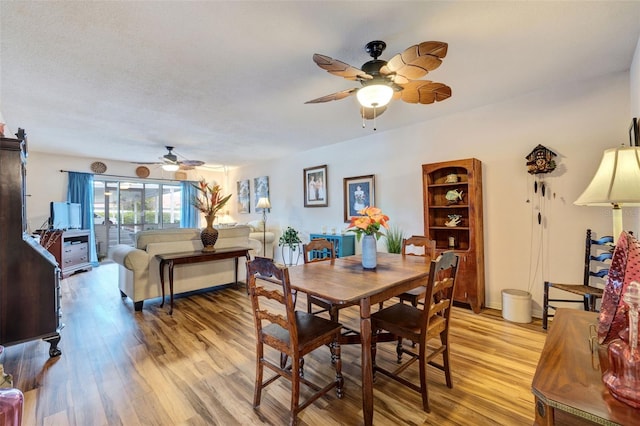 dining area featuring light wood finished floors and ceiling fan