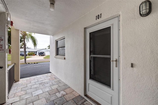 view of exterior entry featuring stucco siding