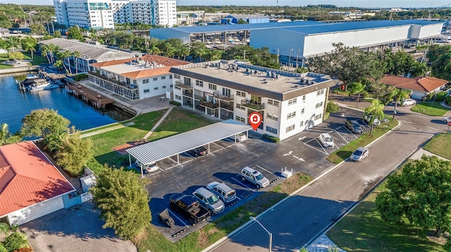 birds eye view of property featuring a city view and a water view