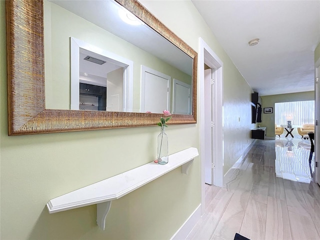 hallway with light hardwood / wood-style flooring