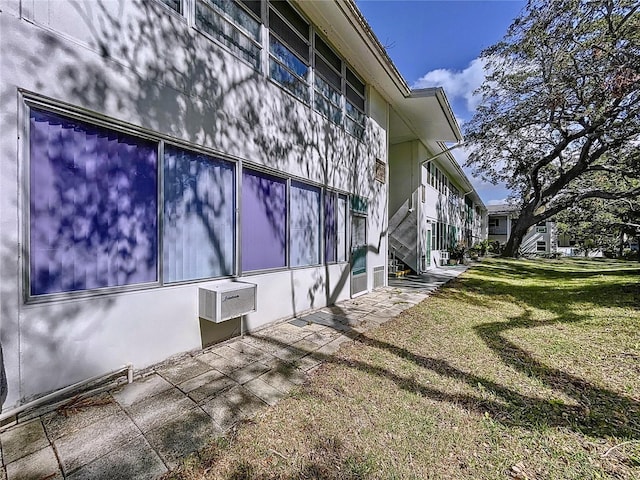 view of property exterior with a lawn