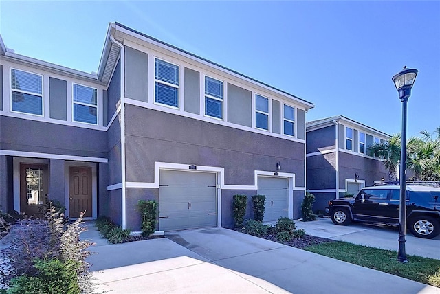 townhome / multi-family property featuring a garage