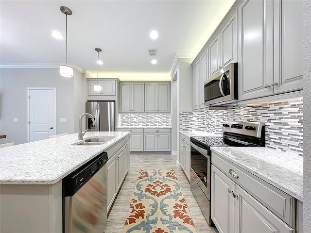 kitchen with sink, light hardwood / wood-style flooring, decorative light fixtures, and stainless steel appliances