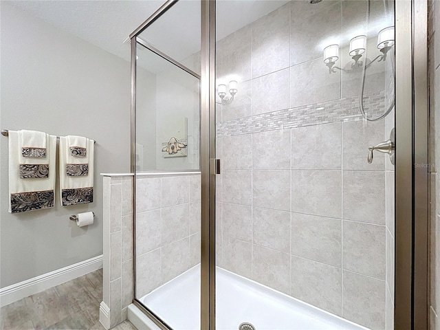 bathroom featuring an enclosed shower and hardwood / wood-style floors