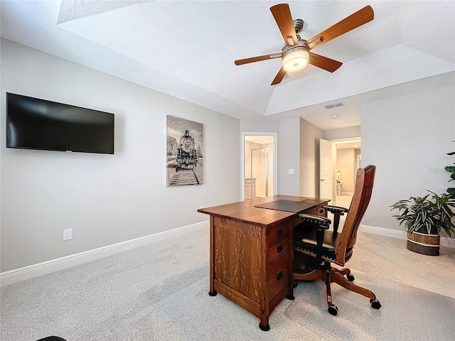 office space with a textured ceiling, light colored carpet, and ceiling fan