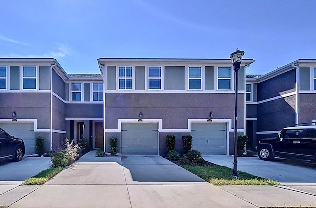 townhome / multi-family property featuring a garage