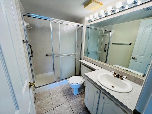 bathroom with toilet, an enclosed shower, vanity, and tile patterned flooring