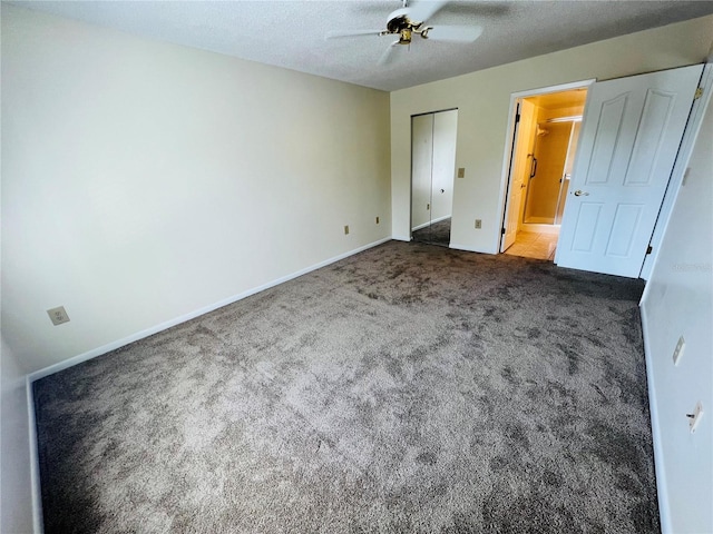 unfurnished bedroom with ceiling fan, a closet, carpet, and a textured ceiling