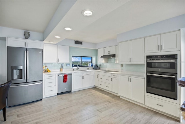 kitchen featuring stainless steel appliances, sink, and white cabinets