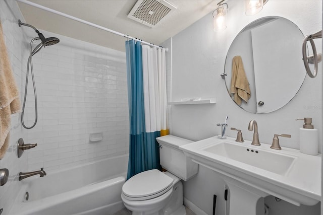 full bathroom featuring sink, shower / tub combo with curtain, and toilet