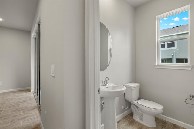 bathroom with toilet and hardwood / wood-style floors