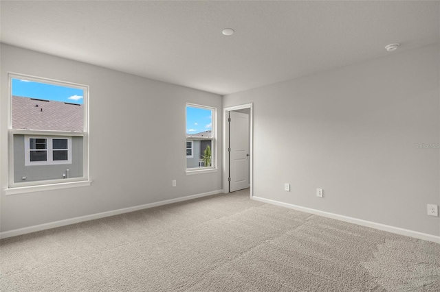 unfurnished room with light carpet