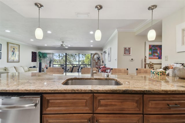 kitchen with ceiling fan, crown molding, light stone countertops, and sink