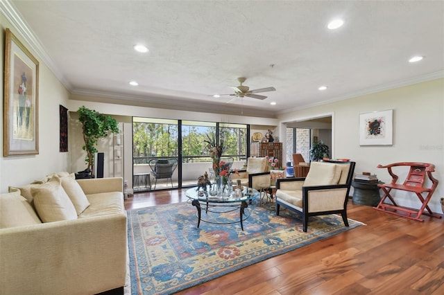 living room with crown molding, hardwood / wood-style flooring, and ceiling fan