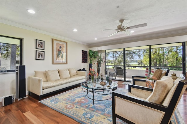 living room with crown molding, a textured ceiling, dark hardwood / wood-style floors, and ceiling fan