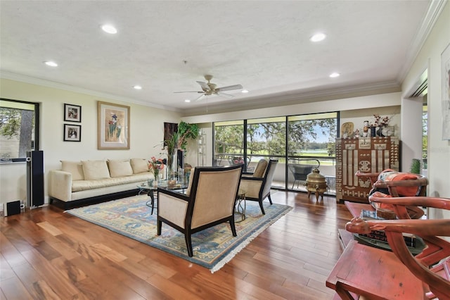 living room with crown molding, dark hardwood / wood-style flooring, and a wealth of natural light