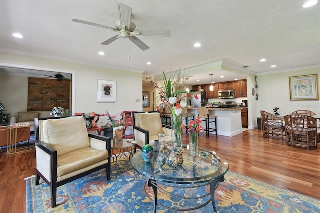 living room featuring ceiling fan, ornamental molding, and dark hardwood / wood-style flooring