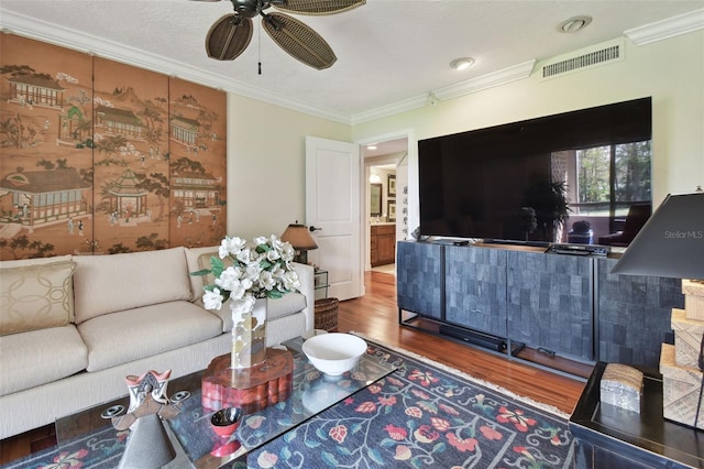 living room featuring crown molding, hardwood / wood-style flooring, and ceiling fan