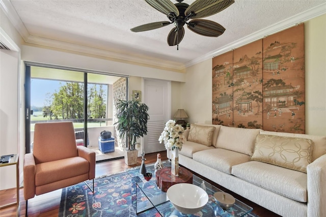 living room with ornamental molding, a textured ceiling, wood-type flooring, and ceiling fan