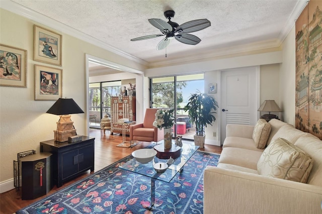 living room with crown molding, hardwood / wood-style flooring, a textured ceiling, and ceiling fan