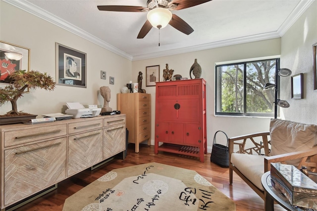 sitting room featuring ceiling fan, ornamental molding, and dark hardwood / wood-style floors