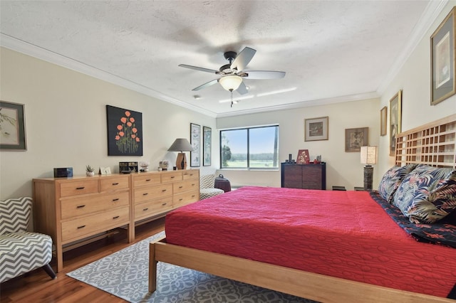 bedroom featuring dark hardwood / wood-style flooring, crown molding, a textured ceiling, and ceiling fan