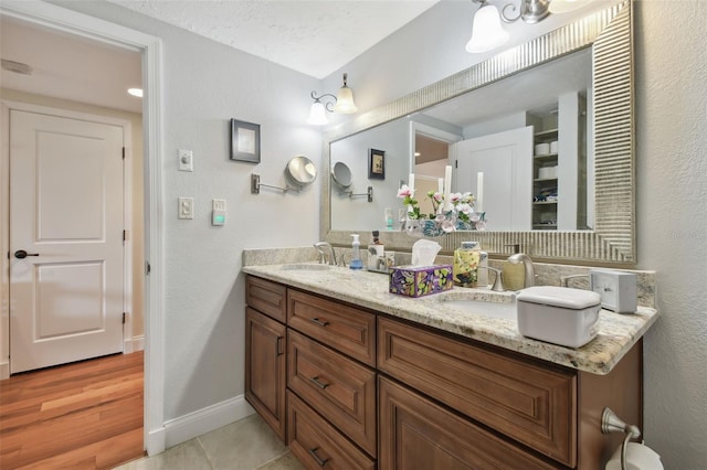 bathroom with vanity, a textured ceiling, and hardwood / wood-style floors