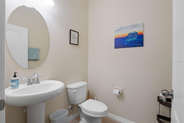 bathroom featuring toilet and tile patterned flooring