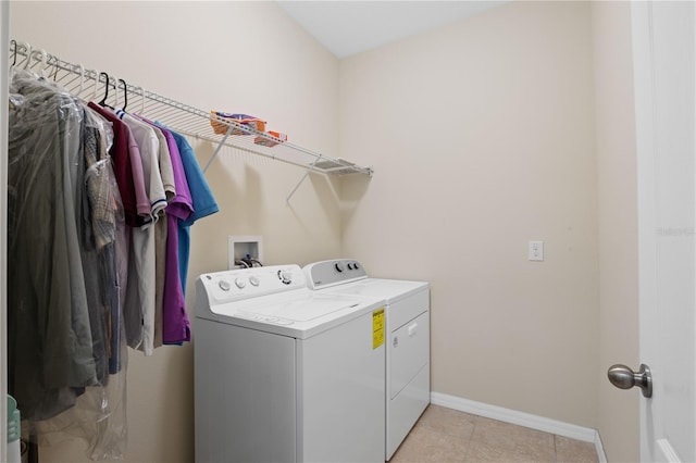 washroom featuring light tile patterned flooring and washer and clothes dryer