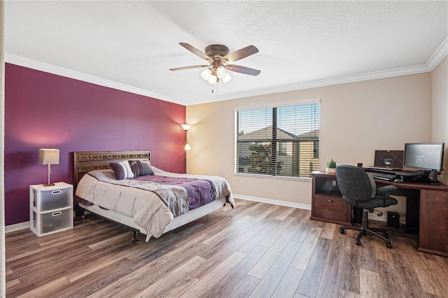 bedroom with ceiling fan, crown molding, a textured ceiling, and hardwood / wood-style floors