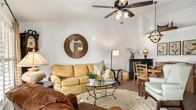 living room with lofted ceiling, wood-type flooring, and ceiling fan