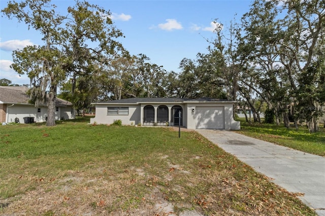 single story home featuring a front lawn and a garage