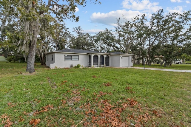 ranch-style house with a front yard and a garage