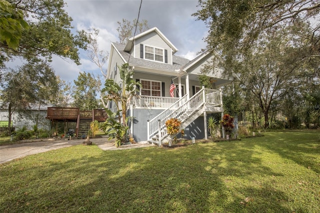 view of front facade featuring a front yard and a deck