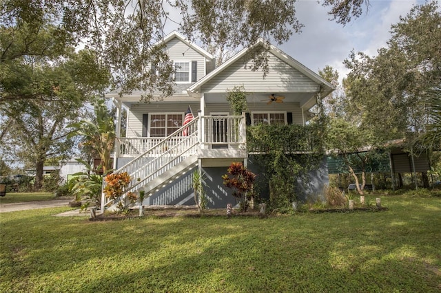 view of front of house with a front yard, a porch, and ceiling fan