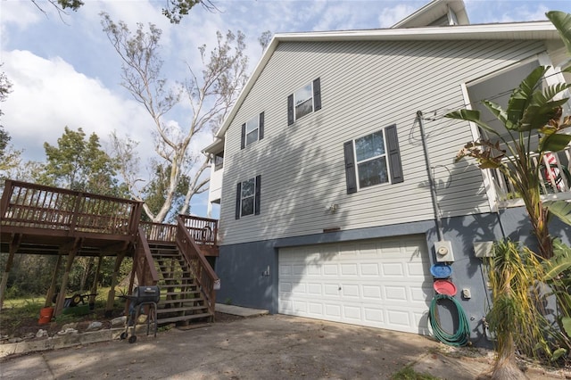 view of side of home with a deck and a garage