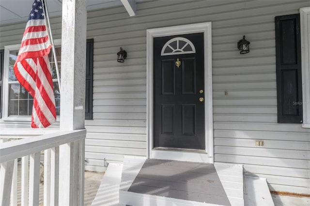 entrance to property featuring covered porch