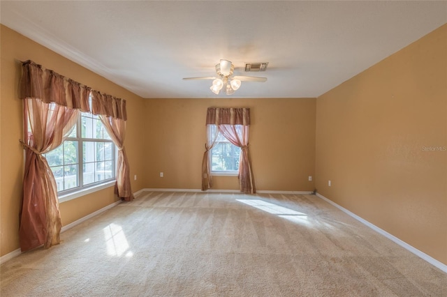 empty room featuring light carpet and ceiling fan