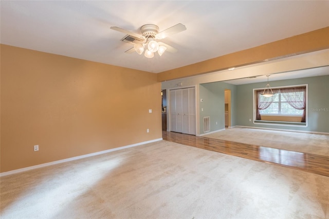 spare room with hardwood / wood-style flooring and ceiling fan