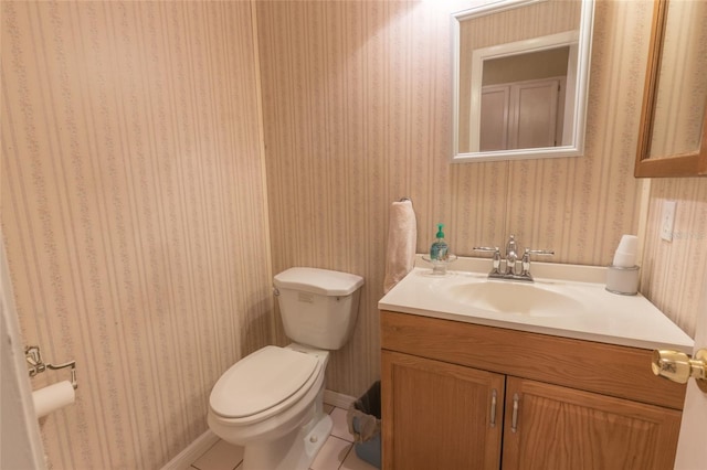 bathroom featuring vanity, toilet, and tile patterned flooring