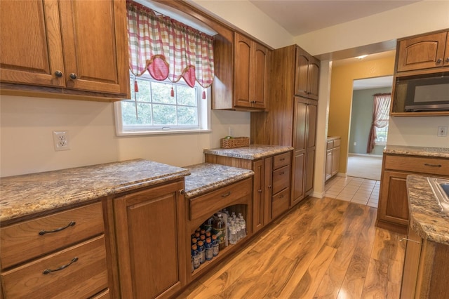 kitchen featuring light hardwood / wood-style flooring and stone counters