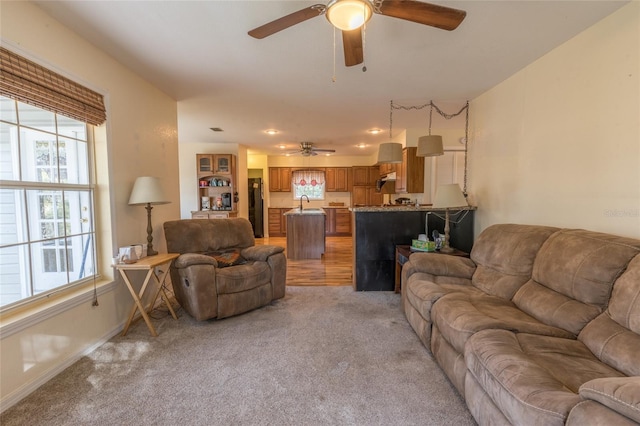 carpeted living room featuring ceiling fan