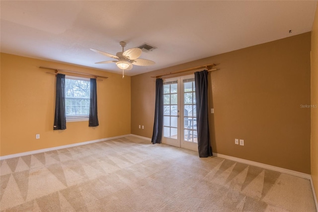 carpeted empty room with a wealth of natural light and ceiling fan